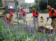 Volunteers plant flowers at Grant Street at First Avenue community flower garden, Downtown Pittsburgh