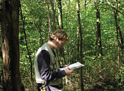 Ephraim Zimmerman, ecology and botany coordinator, reviewing his notes in the field.