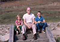 Tissue family descendants Betsy, Bill and Will Scarlett, on the
steps of the former family farmhouse, circa 1961.