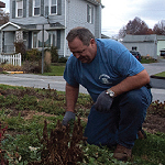 Volunteer Rick Pope digs in a garden he has helped maintain for more than a decade.