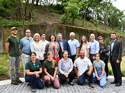 Project partners, including PWSA, ALCOSAN and the City of Pittsburgh, come together to unveil the new bioswale in the Centre and Herron community garden.