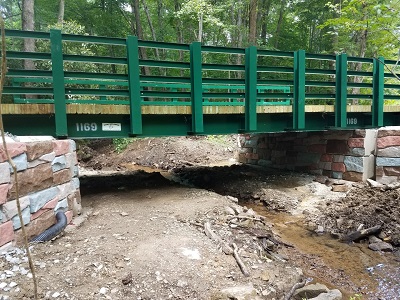 A timberdeck bridge replaced the culvert, allowing for easier aquatic organism passage and more space for water to flow beneath the bridge, reducing the danger of flooding. Brook trout can easily swim upstream. 