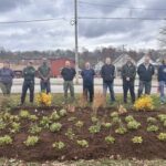Volunteers and WPC staff stand near a newly planted rain garden in Kittanning near the YMCA.