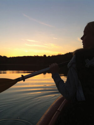Give back to Nature Near You Banner featuring a woman canoeing at Lake Morant